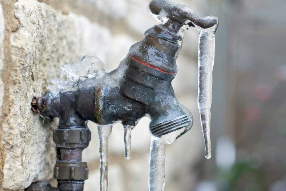 A frozen outdoor faucet that has not been winterized with a frost free spigot